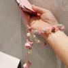 sg-11134201-7rdxl-mcu5tg0lj1a887.webp Stylish Plaster Flower Pendant Crystal Phone Lanyard Holder Antilost Lanyard Lovely Flower Accent